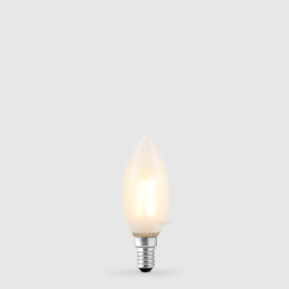 The Liquid LEDs 4W 24 Volt DC Candle LED Bulb E14 Frost in Warm White glows softly with a dimmable, frosted finish against a light gray background.