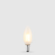 The Liquid LEDs 4W 24 Volt DC Candle LED Bulb E14 Frost in Warm White glows softly with a dimmable, frosted finish against a light gray background.