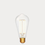 Dulora 4.2W Edison LED Bulb E27 in Extra Warm White illuminated showing warm amber glow through clear ST64 glass