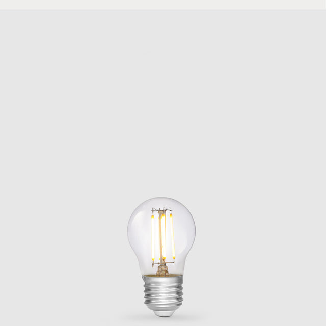 Dulora 4W 12-24 Volt AC/DC Fancy Round LED Bulb E27 in Warm White illuminated with warm light through clear round glass