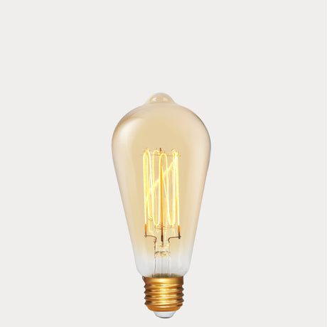 Dulora 4W Edison Vintage LED Bulb E27 in Ultra Warm White glowing deep amber through vintage ST64 glass