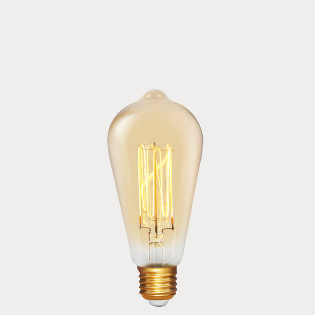 Dulora 4W Edison Vintage LED Bulb E27 in Ultra Warm White glowing deep amber through vintage ST64 glass