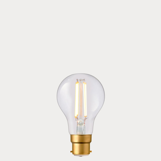 Dulora 6.5W GLS LED Bulb B22 Clear in Extra Warm White glowing with deep warm light through clear A60 glass